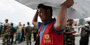 Oxfam volunteer Shekhar Khadka (23) works to off load latrines being delivered to the Tundikhel IDP camp in Kathmandu, Nepal. He is one of 500 volunteers trained to react in the event of an earthquake during the urban risk management program - Credit: Aubrey Wade/Oxfam