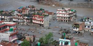 The morning scene in Devighat, Nuwakot, reveals the aftermath of severe flooding. Residents are desperately trying to salvage usable belongings from their inundated homes