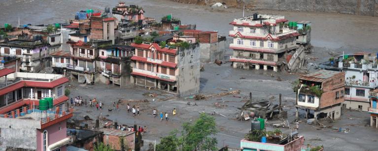 The morning scene in Devighat, Nuwakot, reveals the aftermath of severe flooding. Residents are desperately trying to salvage usable belongings from their inundated homes