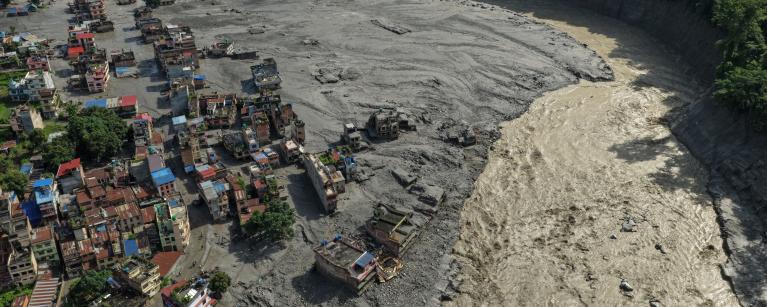 Aerial view of devastation and riverside settlements reduced to ruins in Trishuli Bazaar
