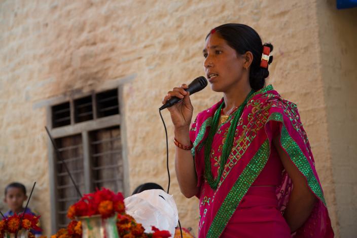 Janaki Oli (28) performs as the master of ceremonies at an event organised by the seed production group in Satmule, Surkhet, Nepal to celebrate International Women's Day - Credit: Aubrey Wade/Oxfam