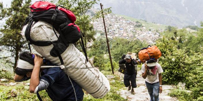 Porters carry relief goods up to remote Laprak village in Gorkha district - Credit: Sam Pickett/Oxfam