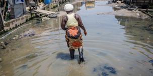 Woman walking through a flooded street in Lagos Nigeria