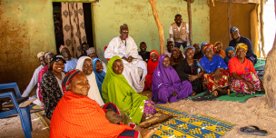 Kubuku Ward community members participating in joint planning sessions to restore shared trade routes and dissolve historical borders.