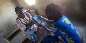 Enumerator interviewing a Household member during a VSLA Baseline Survey