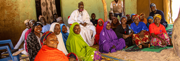 Kubuku Ward community members participating in joint planning sessions to restore shared trade routes and dissolve historical borders.