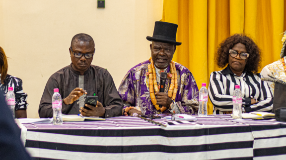 Traditional leader addressing the room on oil spill compensation and environmental justice in the Niger Delta.