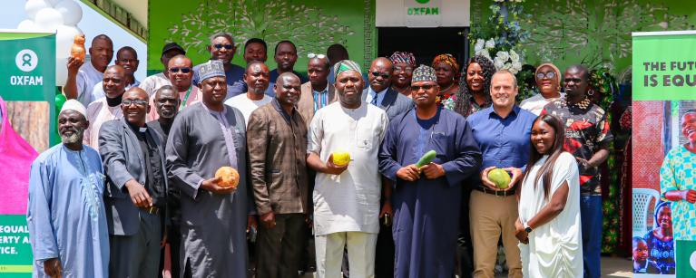 Oxfam Interim Country Director, alongside partners and government stakeholders holding farm harvest in Jos, Plateau State