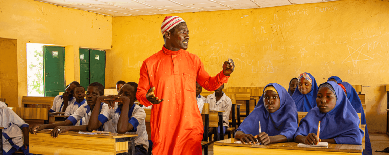Volunteer teacher Kamal Bawa instructing a classroom of students in Borno State Nigeria.