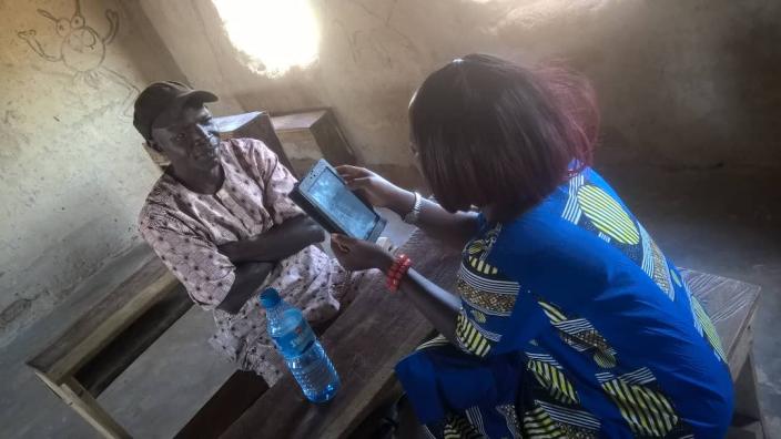 Enumerator interviewing a Household member during a VSLA Baseline Survey