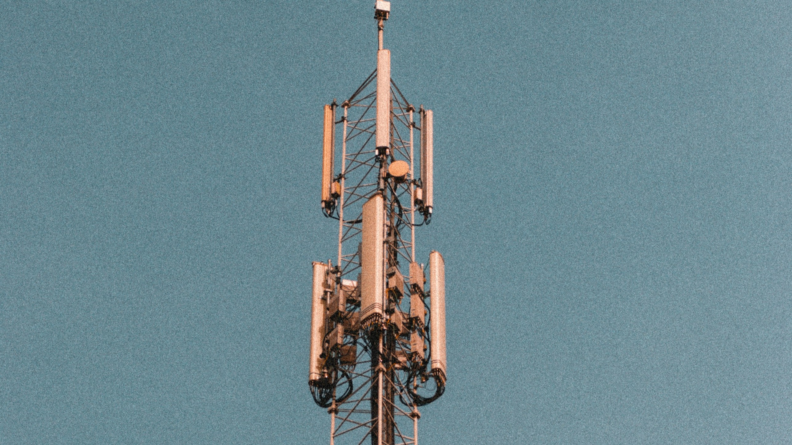 A cell tower against a blue sky.
