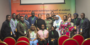 Group photo of attendees and speakers at a DRIF panel, gathered and smiling for the camera.