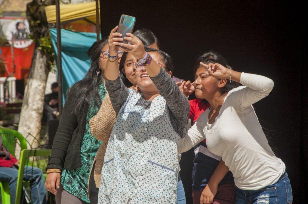 A group of women smiling and posing for a selfie