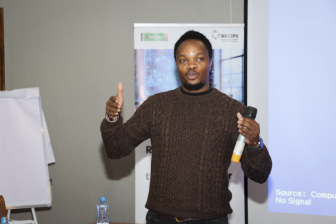 A man speaks to a group gathered for digital rights training held by Mzalendo Trust in Kenya.