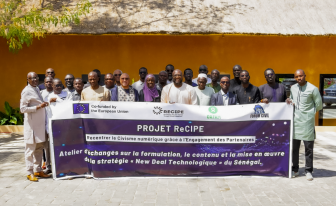 ReCIPE colleagues in Senegal pose for a group photo while holding a ReCIPE banner.