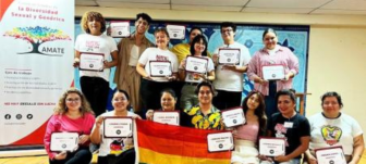 Members of AMATE pose for a group photo while holding certificates.