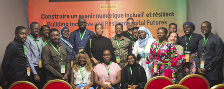 Group photo of attendees and speakers at a DRIF panel, gathered and smiling for the camera.