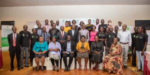 Oxfam staff, partners and local government officials in a group photo during the Empower@Scale closing event