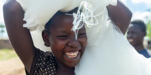 Esperanza, 16, after receiving a mosquito net in Kyakya II. “We depend on the external help here,” she says. Photo credit: Viktorija Jeras / Oxfam