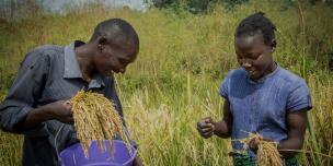 YEEP beneficiaries Josiah and Gladys while working in their garden