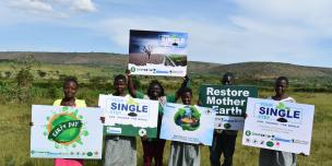 A group photo of Oxfam staff and partners on World Earth Day in Isingiro district