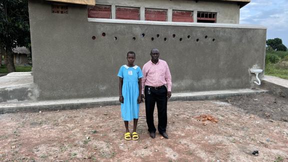 Mr. Yusufu, Head teacher Manafa primary school and Jamira, a pupil during monitoring and supervision.jpg