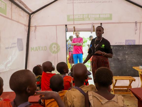 Adome Mary, a teacher, speaking to learners at Utut mobile school in K.jpg