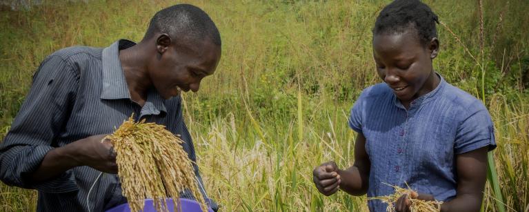 YEEP beneficiaries Josiah and Gladys while working in their garden