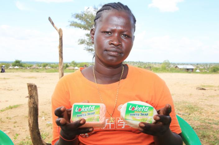 South Sudanese Refugee Farida Hatayi, 28 year old mother of 4, displays bathing soap made her Loketa Soap Making Gro