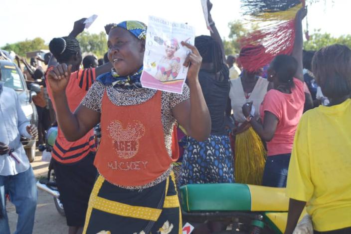 A female supporter holds up Grace's campaign flier, showing her support. Photo credit: Jose Mario.jpg