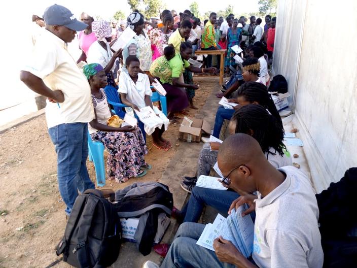 Oxfam officials verifying Refugees with special needs during cash distribution exercise in Imvepi Photo By Robert Ariaka/Oxfam