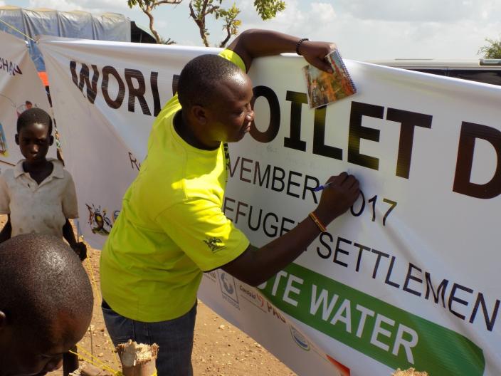 Public Health Promotion Team Leader Rashid Mawejje in Ofua 3 during World Toilet Day commemoration. photo credit:Oxfam