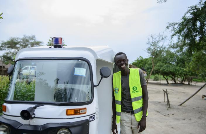 Scopas Bahir from Rhino settlement and and the ambulance he uses to take those who need transportation to and from medical facilities within the settlement. Photo credit: Julius Caesar/Oxfam