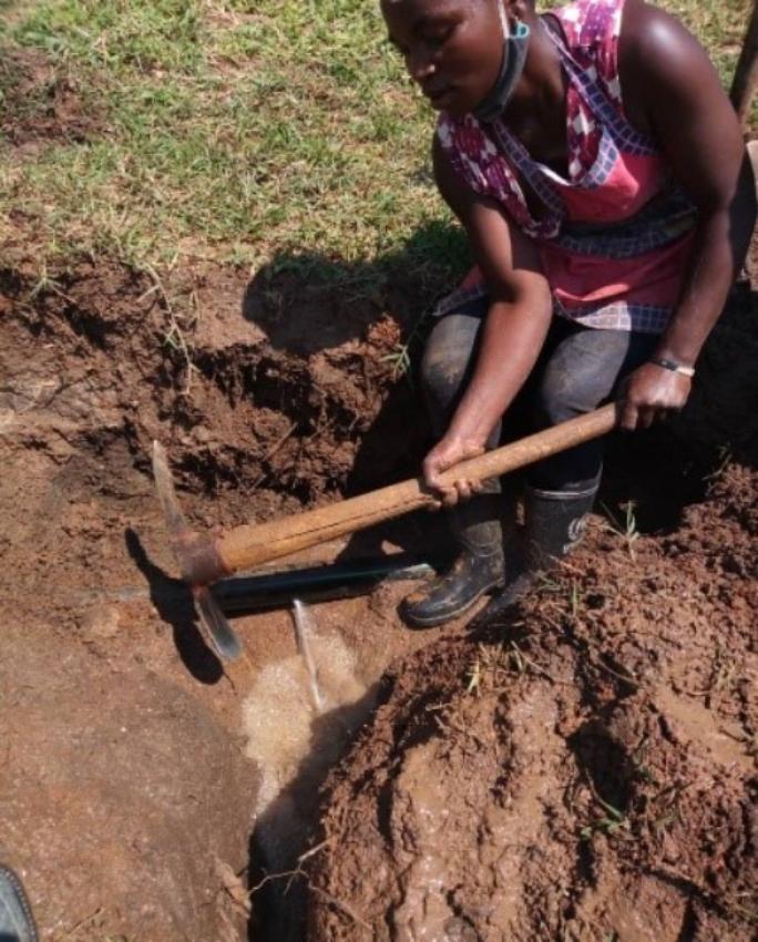 Tantine excavating a pipeline trench before becoming a pump attendant at Sweswe Pump Station. Photo by Margret Kyobusingye, Oxfam (1).jpg