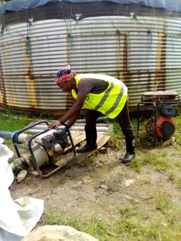 Tantine operating a surface pump at Sweswe Pump Station. Photo by Joyce Amuron, Oxfam.jpg