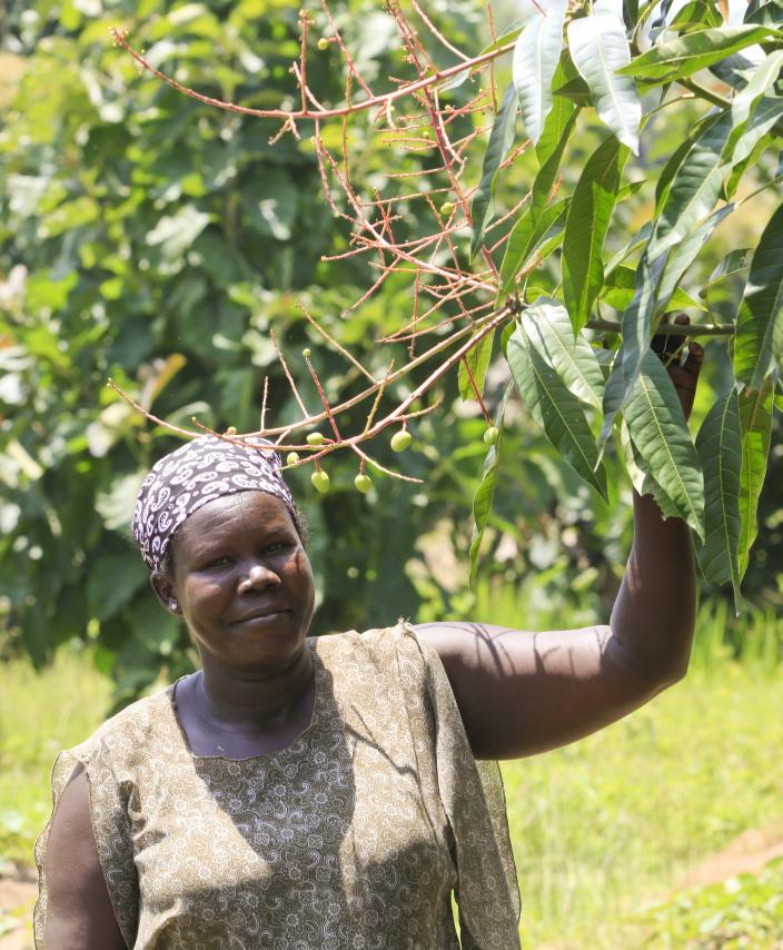 Vita from Arua by her mango tree. She says "I  believe in taking care of the environment because we  live off it and if it’s destroyed, we will not survive. "